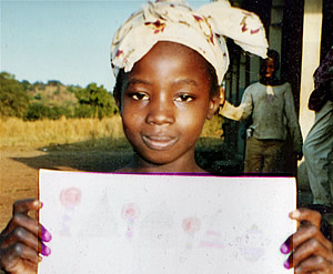 Third grade student in Kabe, Mali displays artwork she created for exchange with partner class in Albany, NY.